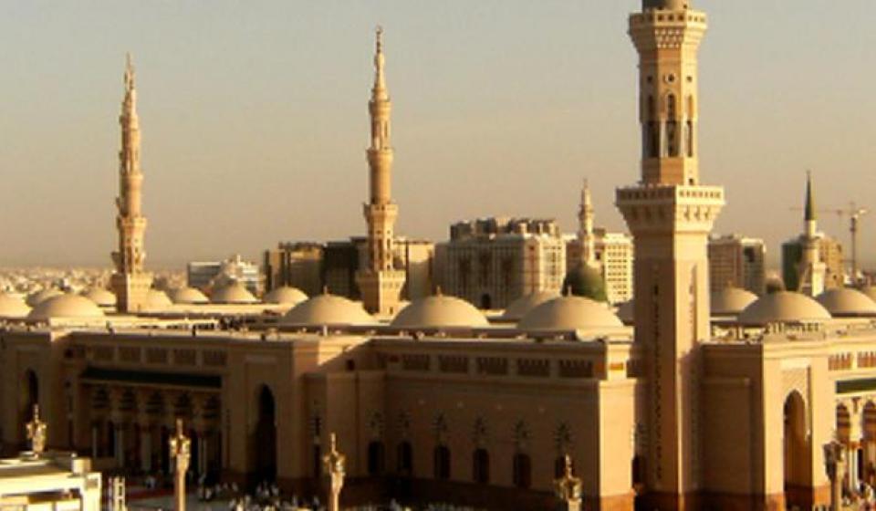 Beige and tan buildings in Saudi Arabia with dusty sky in background