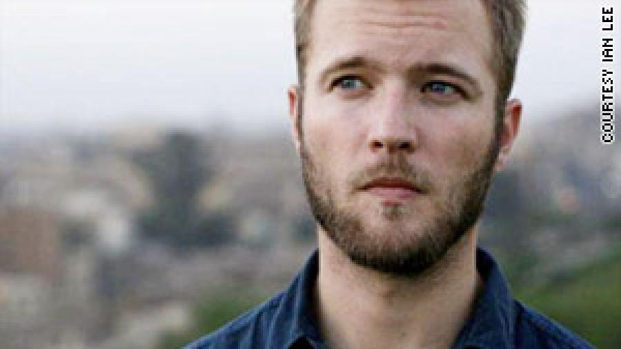 Young man with beard looking off to the side
